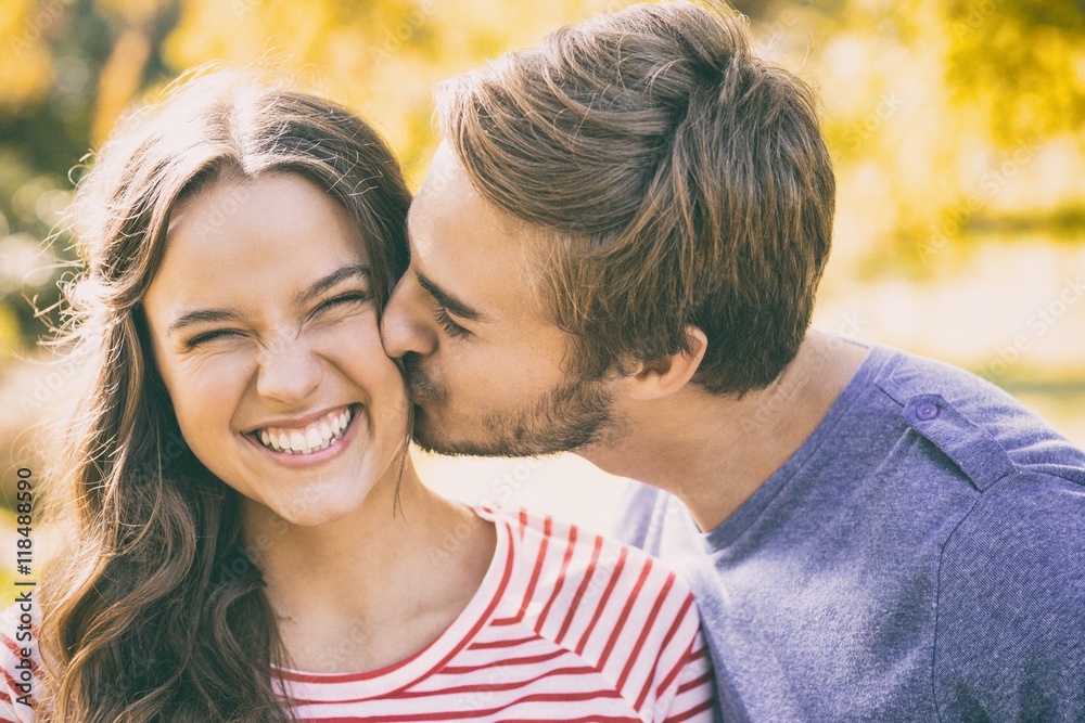 Cute couple kissing in the park Cute couple kissing in the park