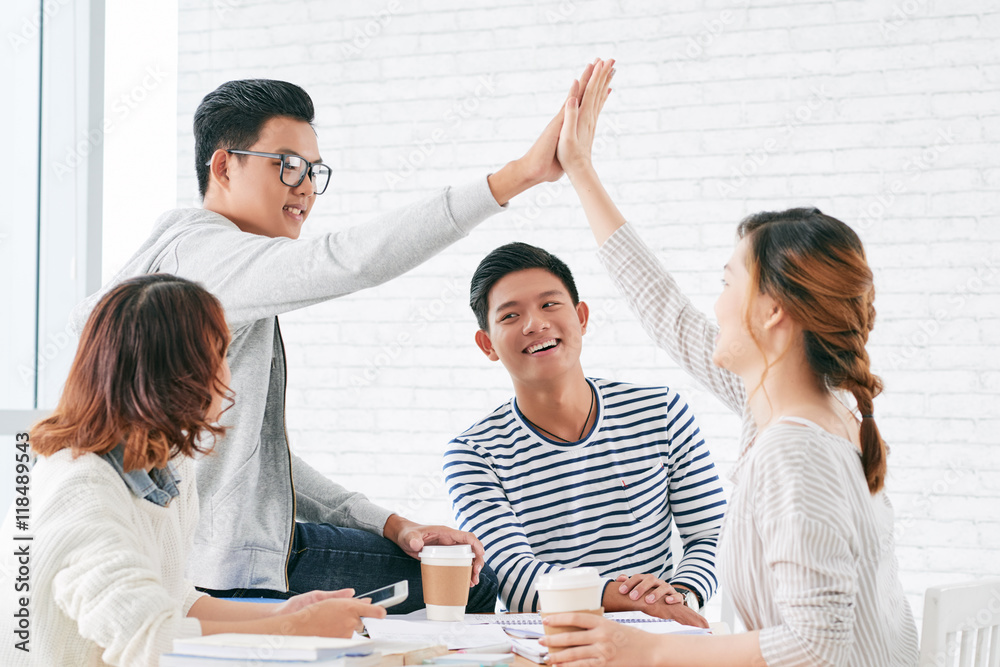 Fototapeta premium Student giving high five after finishing project