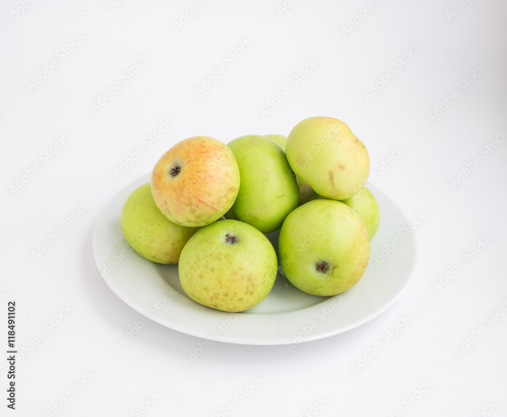 Green and red apples on a white plate Green and red apples on a white plate