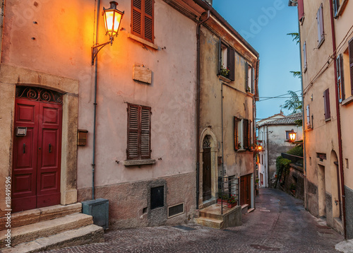 Narrow street in the old town at night in Italy © arbalest