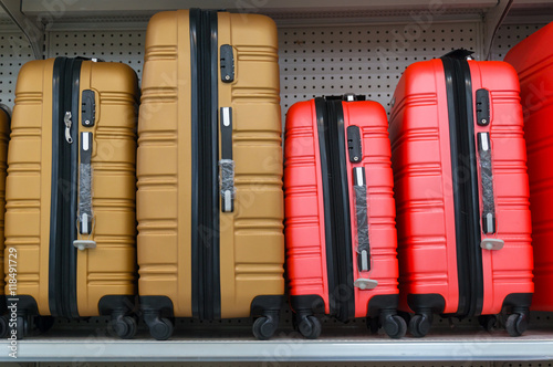 suitcases in a row on shelf