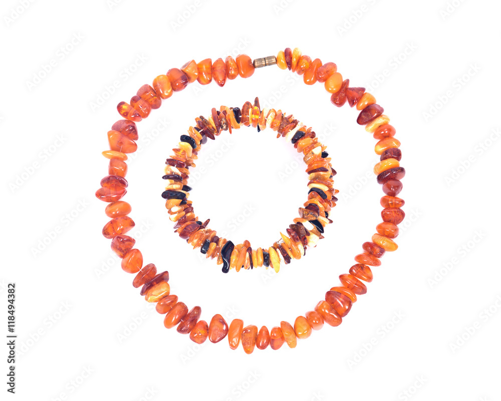 Obraz premium Raw Polished Adult Baltic Amber Necklace and Bracelet Separated on White Background