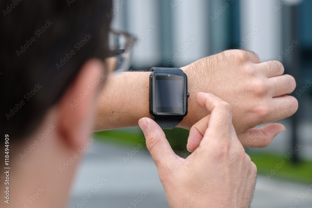 Man using smart watch outdoors