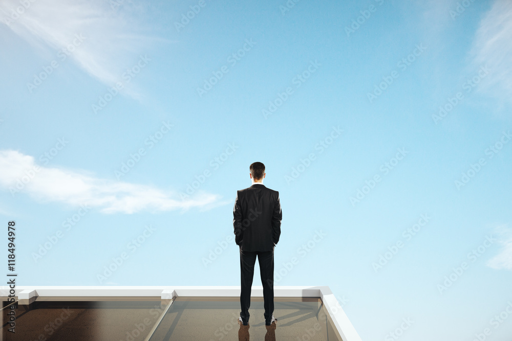 Businessman looking at sky