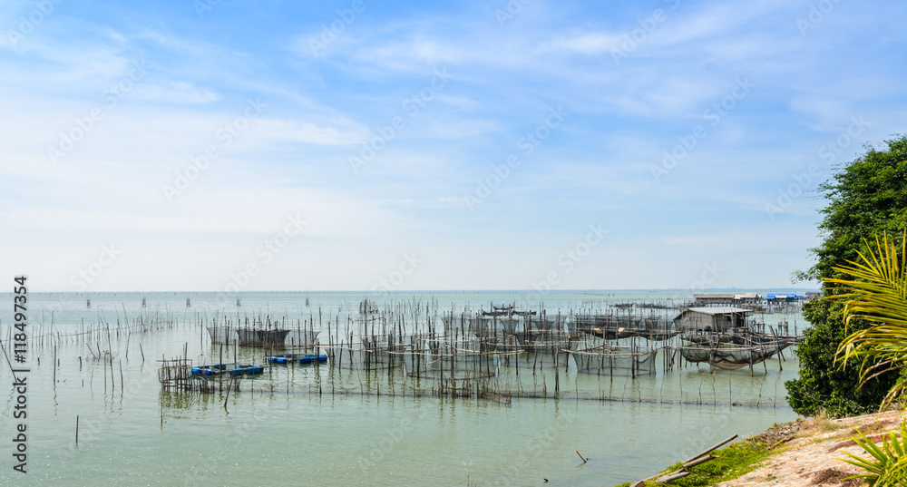 Fish farming in the sea, floating house with cages under for rearing fish in Thailand Fish farming in the sea, floating house with cages under for rearing fish in Thailand