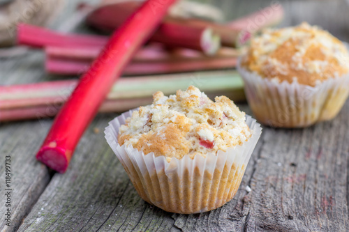 Detail on a Rhubarb muffin with rhubarb petioles in the backgrou