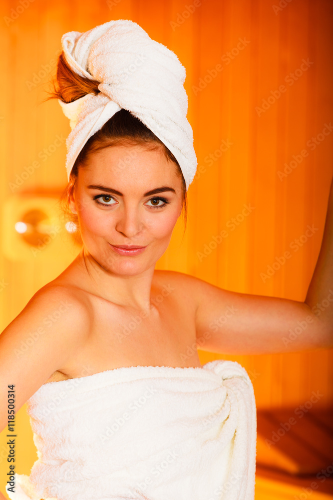 woman relaxing in wooden sauna room woman relaxing in wooden sauna room