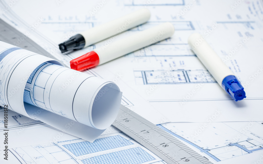 Rolled architectual plans with marker pens and ruler Rolled architectual plans with marker pens and ruler