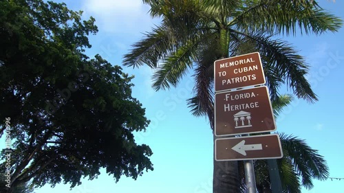 Florida heritage street sign pointing to Cuban Patriots Memorial site, located on Calle Ocho aka 8th street in Little Havana, Miami, Florida