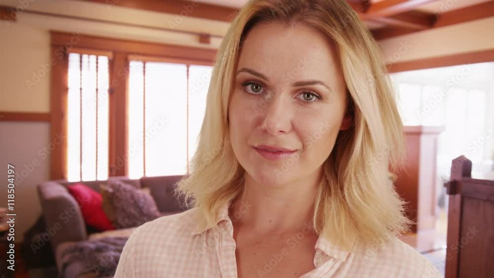 Woman looking at camera while at home Woman looking at camera while at home
