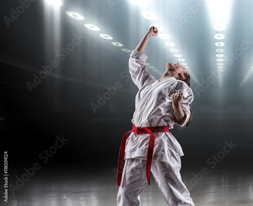 Sexy girl in a kimono karate rejoices victory