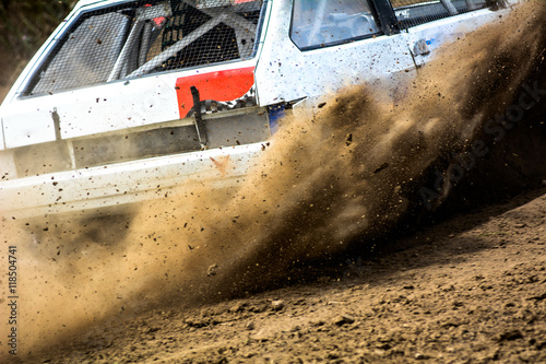 Autocross on a dusty road. Close-up of car in competition up road on a dirt road. Powerful auto throws dirt