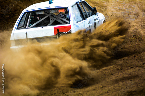 Fototapeta Naklejka Na Ścianę i Meble -  Autocross on a dusty road. Powerful auto throws dirt