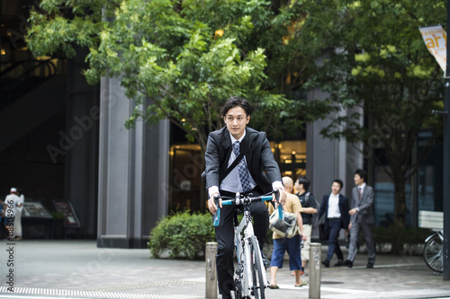 Cool businessman is riding the road bike