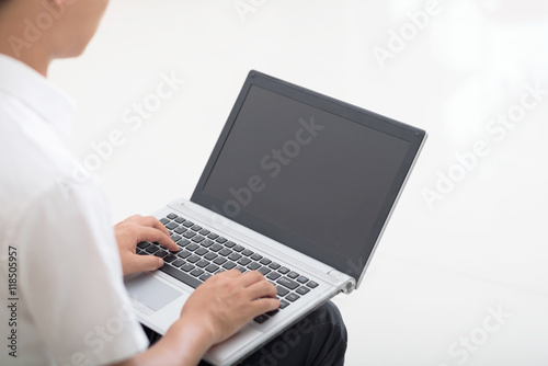 Young man using laptop for work.
