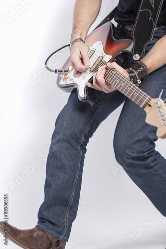 Professional Guitar Musician Legs Closeup. Posing Against White