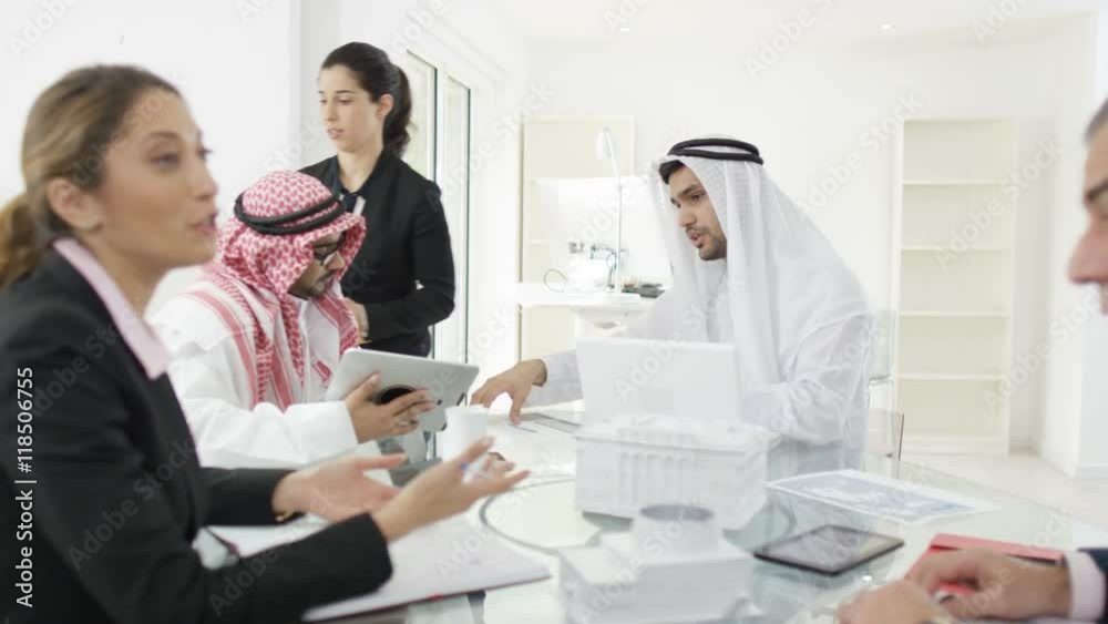 Middle Eastern & Western business group discussing ideas in a meeting Middle Eastern & Western business group discussing ideas in a meeting