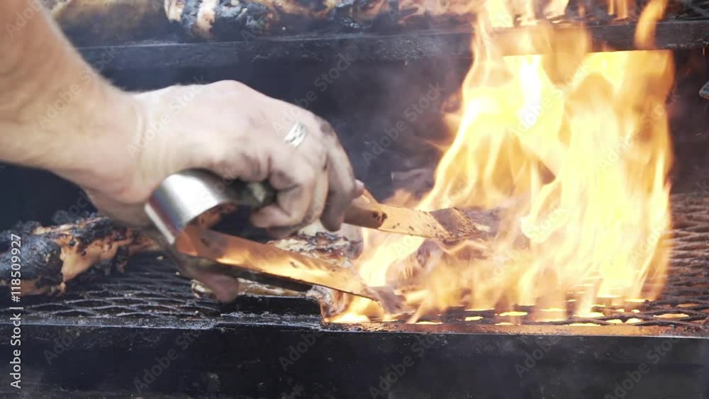 slow motion BBQ chicken on an outdoor grill
