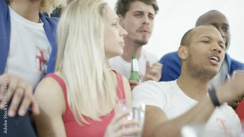 Friends watching sports game on TV have negative reaction to action on screen Friends watching sports game on TV have negative reaction to action on screen