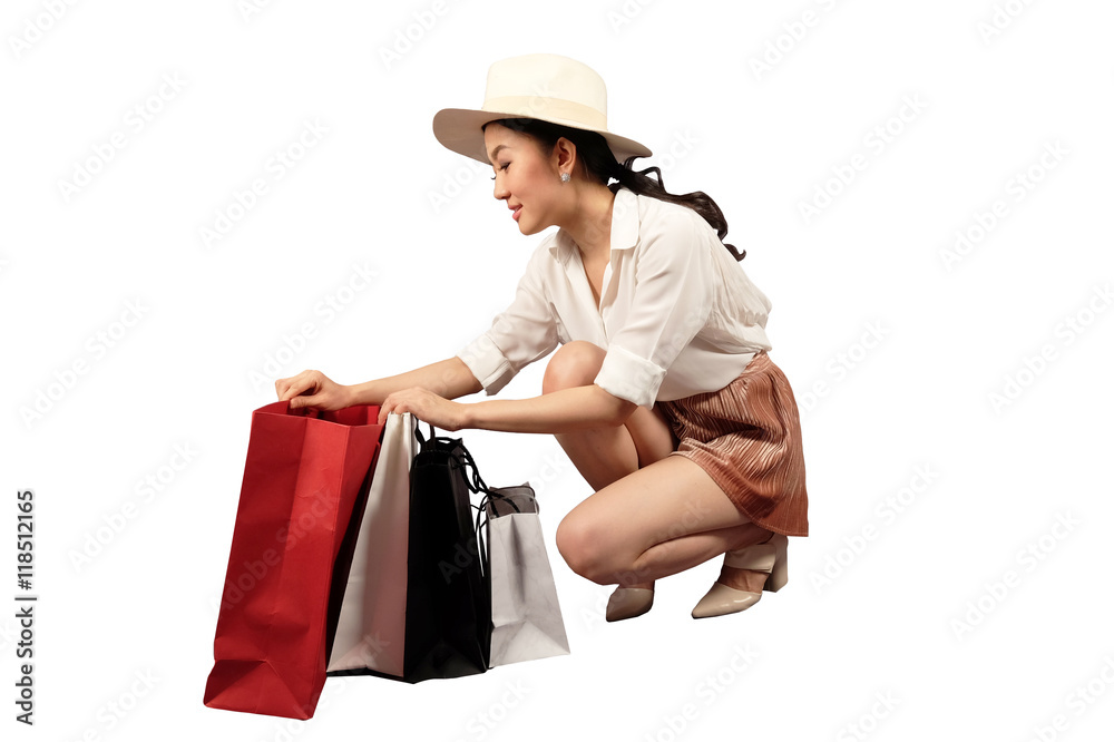 Shopaholic -Young stylish woman feeling happy while opening her shopping bags Shopaholic -Young stylish woman feeling happy while opening her shopping bags
