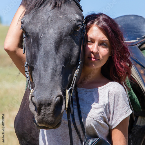 Beautiful girl and black horse in nature. Kiev, Ukraine