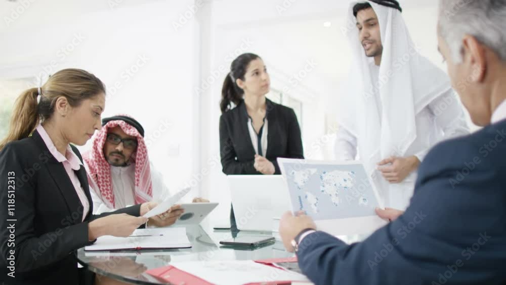 Middle Eastern & Western business group discussing ideas in a meeting Middle Eastern & Western business group discussing ideas in a meeting