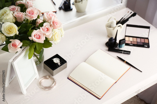 Fotografering Cosmetic and notebook on light dressing table