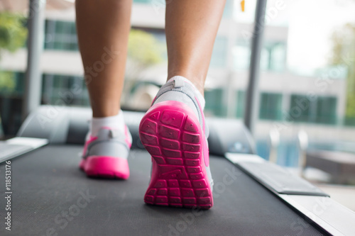 Jogging on treadmill, focus on the treadmill, blurred motion 
