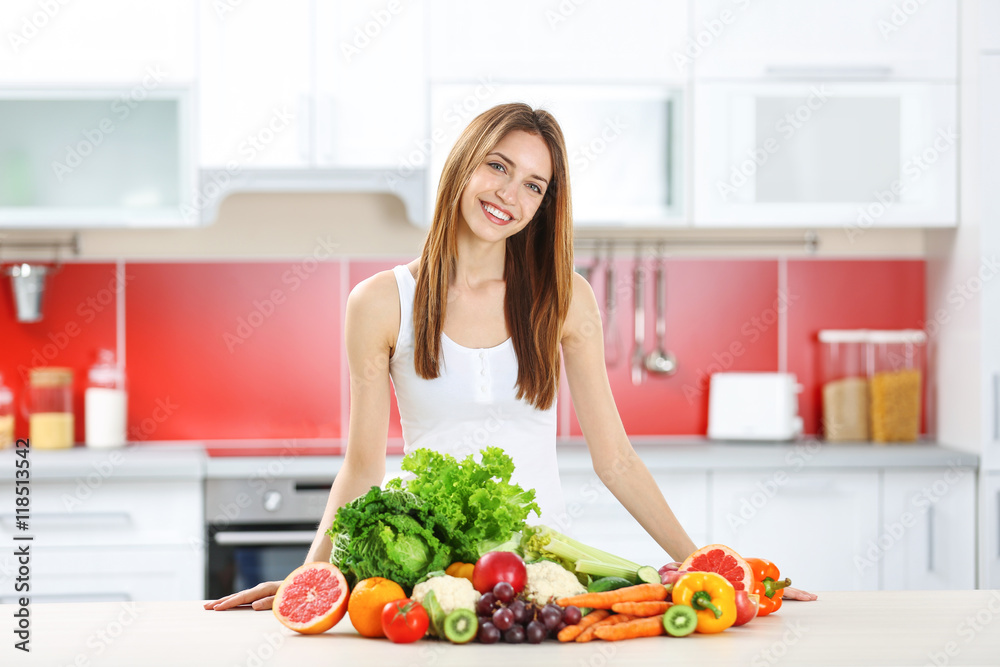Young woman with fresh vegetables and fruits in kitchen. Diet concept Young woman with fresh vegetables and fruits in kitchen. Diet concept