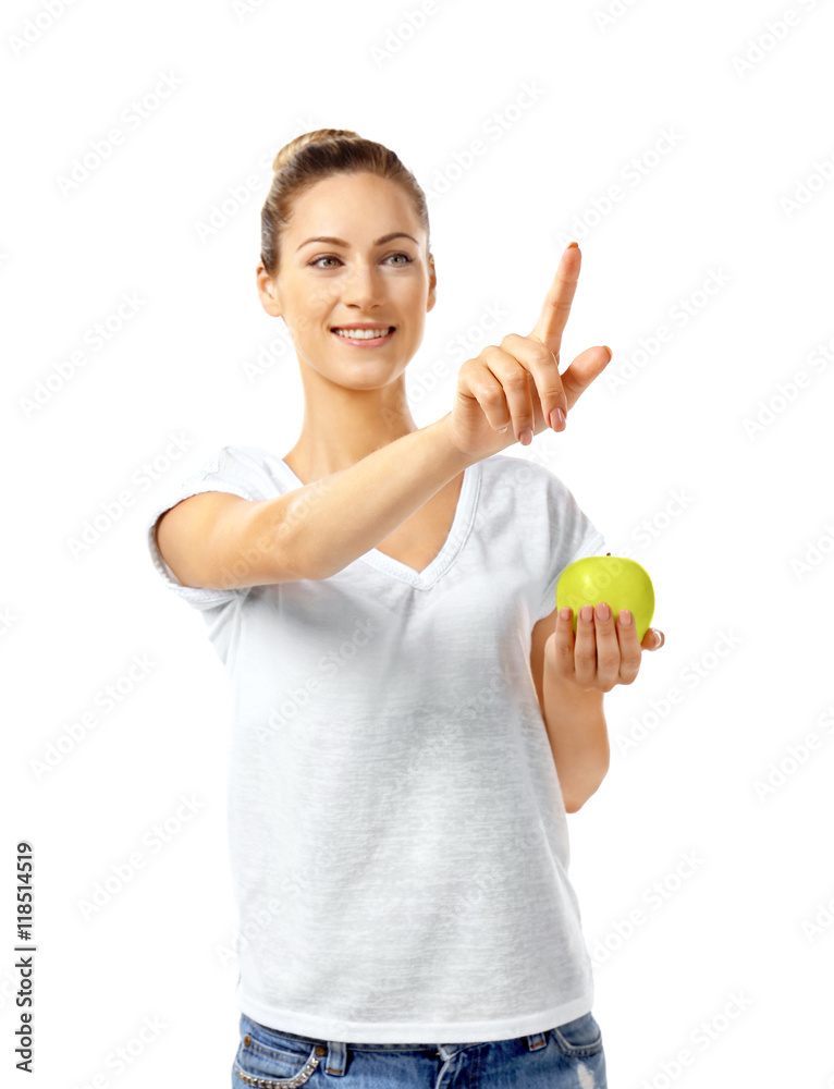 Beautiful girl with apple pointing finger, isolated on white Beautiful girl with apple pointing finger, isolated on white