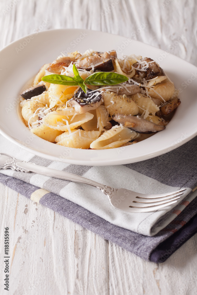 Italian cuisine: Conchiglie with porcini and parmesan close-up. Vertical
Italian cuisine: Conchiglie with porcini and parmesan close-up. Vertical
