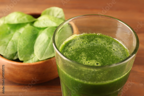 Tasty spinach smoothie drink on table, closeup
