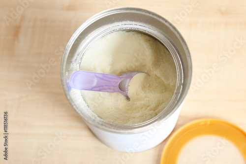 Baby milk formula in can on wooden background