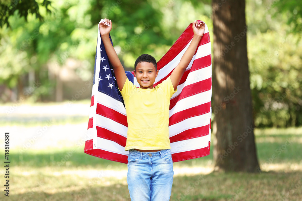Boy with American flag in park