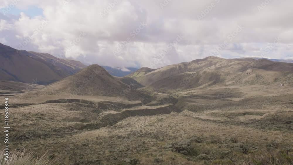 Rear view of a young woman sitting on a mountain top peacefully gazing the valley of a Colombian Volcano. 4k Rear view of a young woman sitting on a mountain top peacefully gazing the valley of a Colombian Volcano. 4k