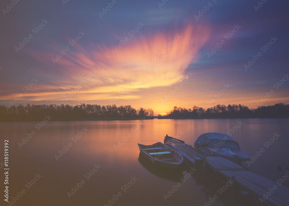 Marina on the lake, boats moored to a wooden pier, retro colors