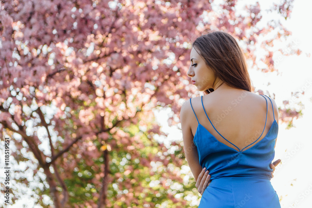 Beautiful young woman standing near the apple tree. Beautiful young woman standing near the apple tree.