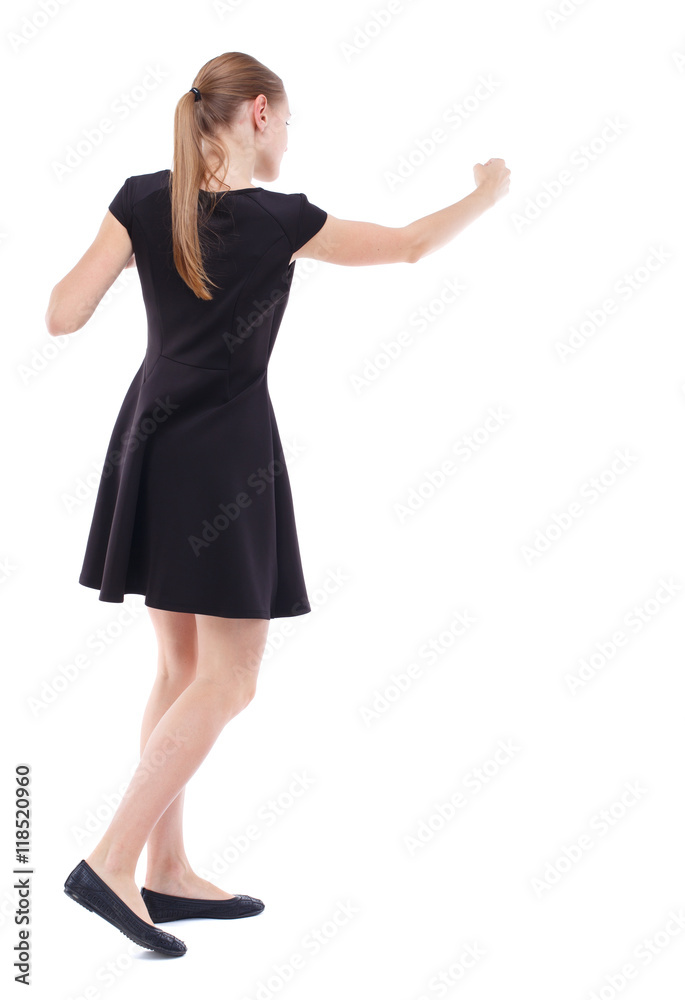 skinny woman funny fights waving his arms and legs. Isolated over white background. Blonde in a short black dress boxing skinny woman funny fights waving his arms and legs. Isolated over white background. Blonde in a short black dress boxing