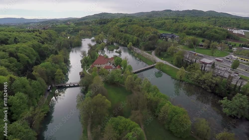 There is a beautiful green island with a castle on it. There are many trees and forests around. Wide-angle shot.
There is a beautiful green island with a castle on it. There are many trees and forests around. Wide-angle shot.