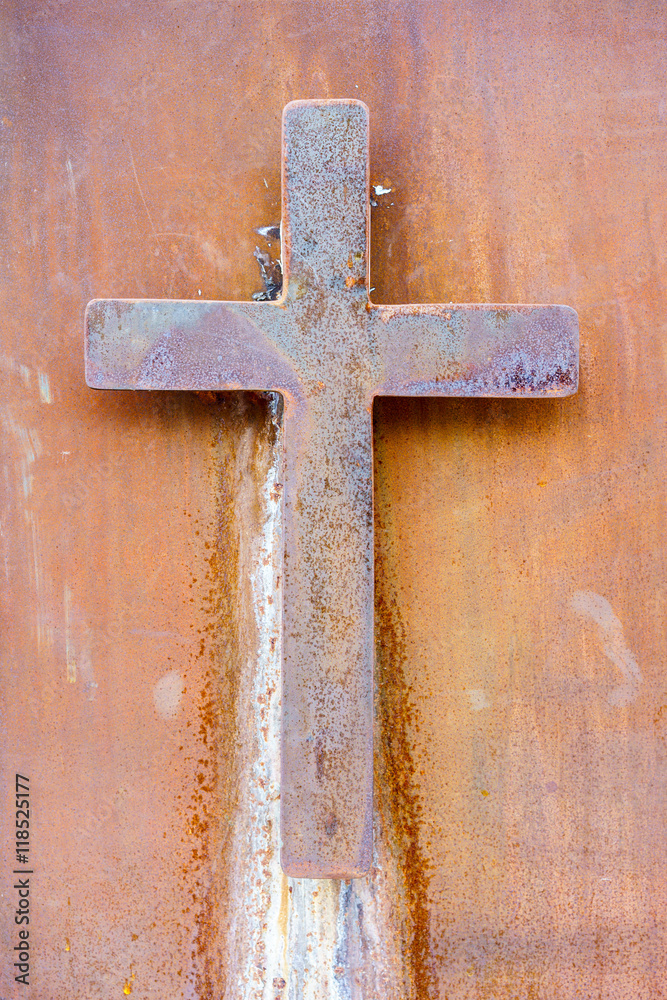 Catholic rusty cross on wall