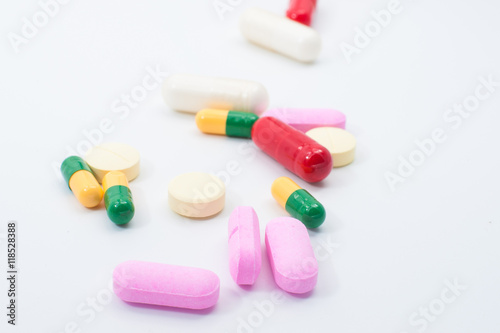 Pills and capsules on white background