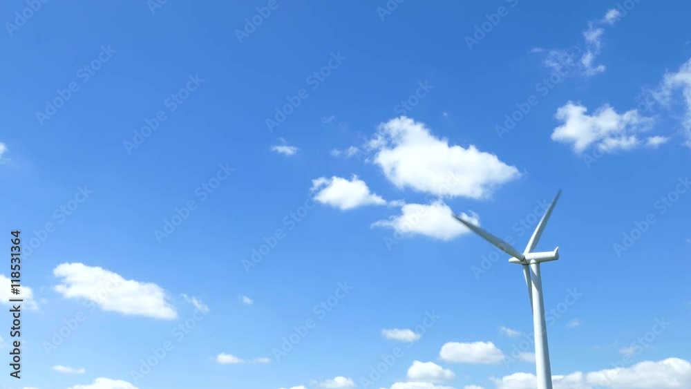 Single turning wind turbine against a blue sky summers day Single turning wind turbine against a blue sky summers day
