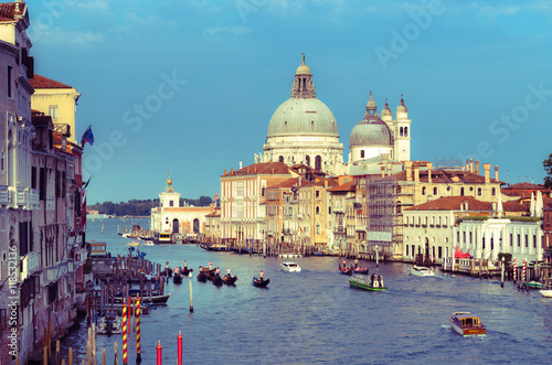 Gorgeous view of the Grand Canal and Basilica Santa Maria della Salute during sunset with interesting clouds, Venice, Italy © gatsi