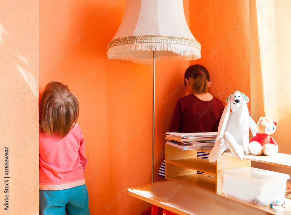 Children standing in corner as punishment Stock Photo | Adobe Stock