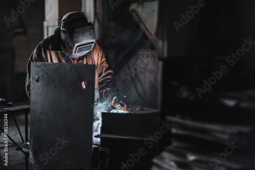 job of a welder. A large concrete products plant and welding on it. photo