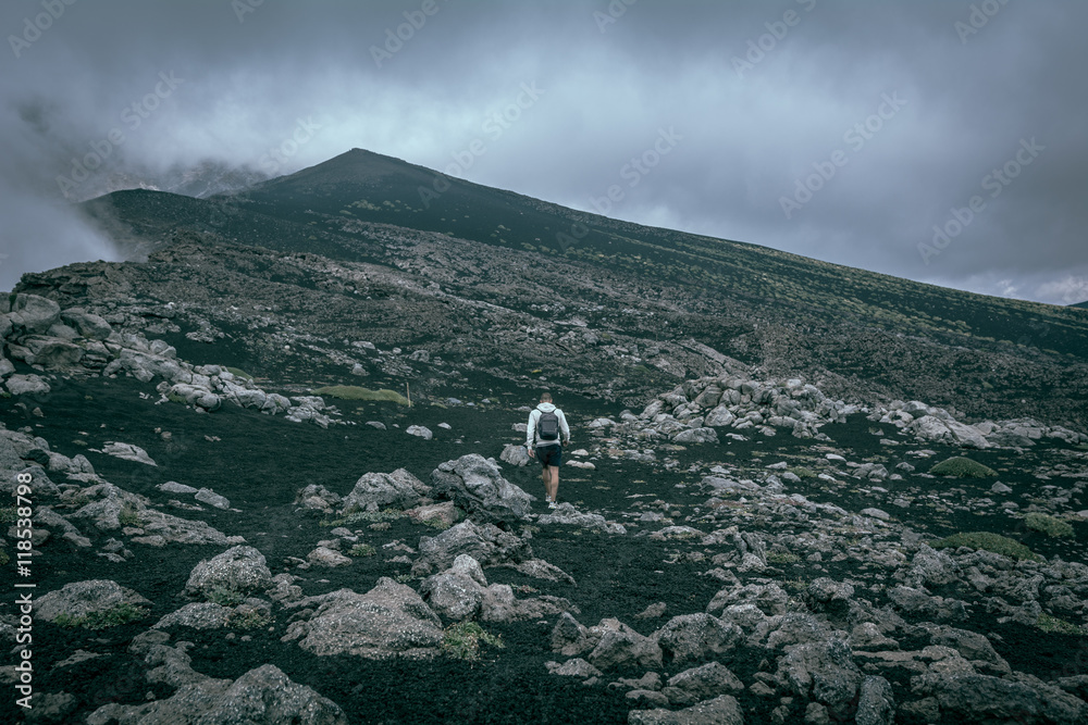 Man walking in the mountain in a foggy day