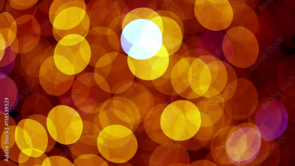 Colorful defocused bokeh Christmas lights blinking on a Christmas tree. Red and yellow lights. Colorful defocused bokeh Christmas lights blinking on a Christmas tree. Red and yellow lights.