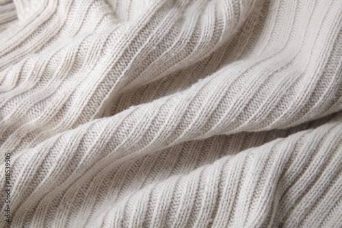 A full page close up of cream chunky knit sweater fabric texture