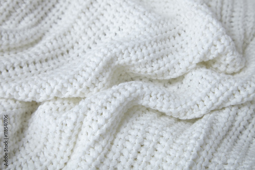 A full page close up of white knitted sweater material texture