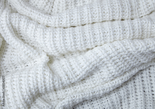 A full page close up of cream knitted material texture